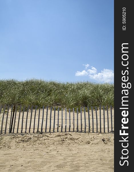 A fence at the beach on a clear day. A fence at the beach on a clear day.