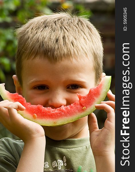 A boy is happy to eat and enjoy health foods like watermellon. A boy is happy to eat and enjoy health foods like watermellon