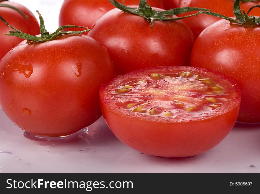 Fresh tomatoes wtih water drops.