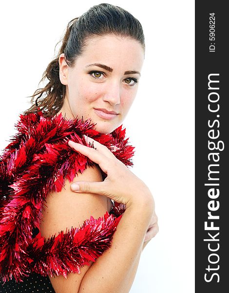 Portrait of a beautiful young brunette woman with tinsel for Christmas. Portrait of a beautiful young brunette woman with tinsel for Christmas.