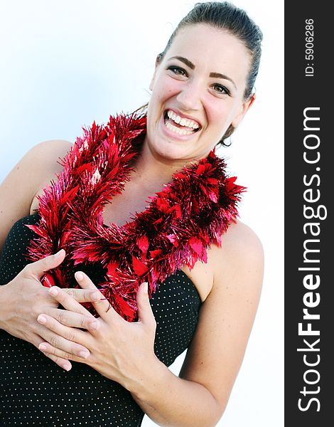 Portrait of a beautiful young brunette woman with tinsel for Christmas - isolated. Portrait of a beautiful young brunette woman with tinsel for Christmas - isolated.