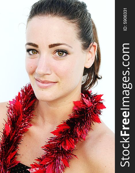 Portrait of a beautiful young brunette woman with tinsel for Christmas - isolated. Portrait of a beautiful young brunette woman with tinsel for Christmas - isolated.
