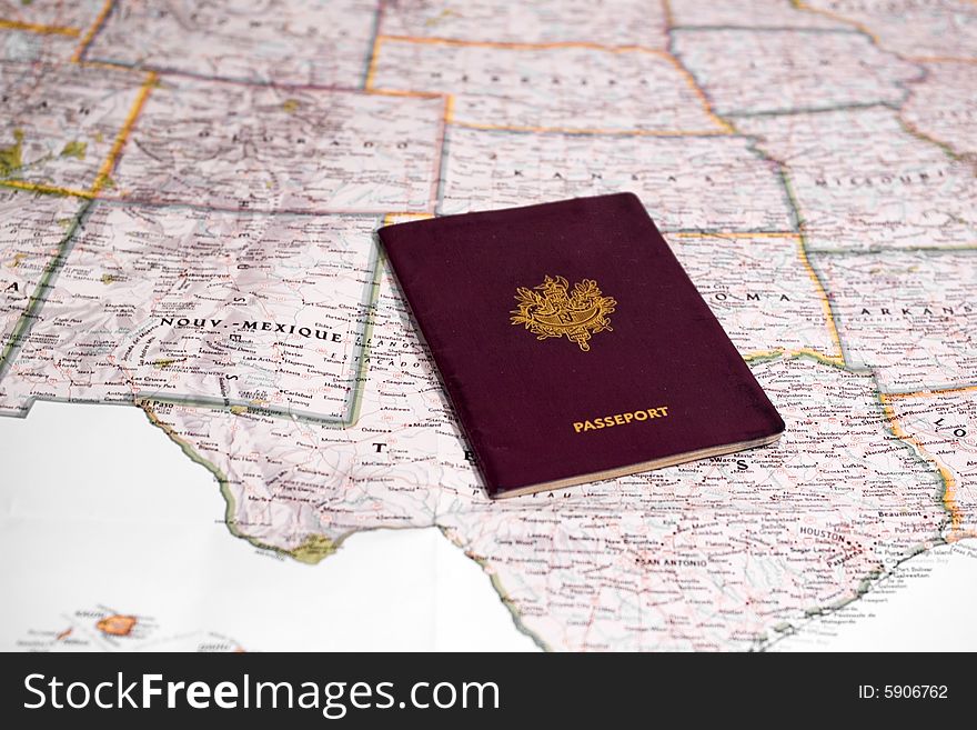 A passport laying on a map of yhe united states. A passport laying on a map of yhe united states