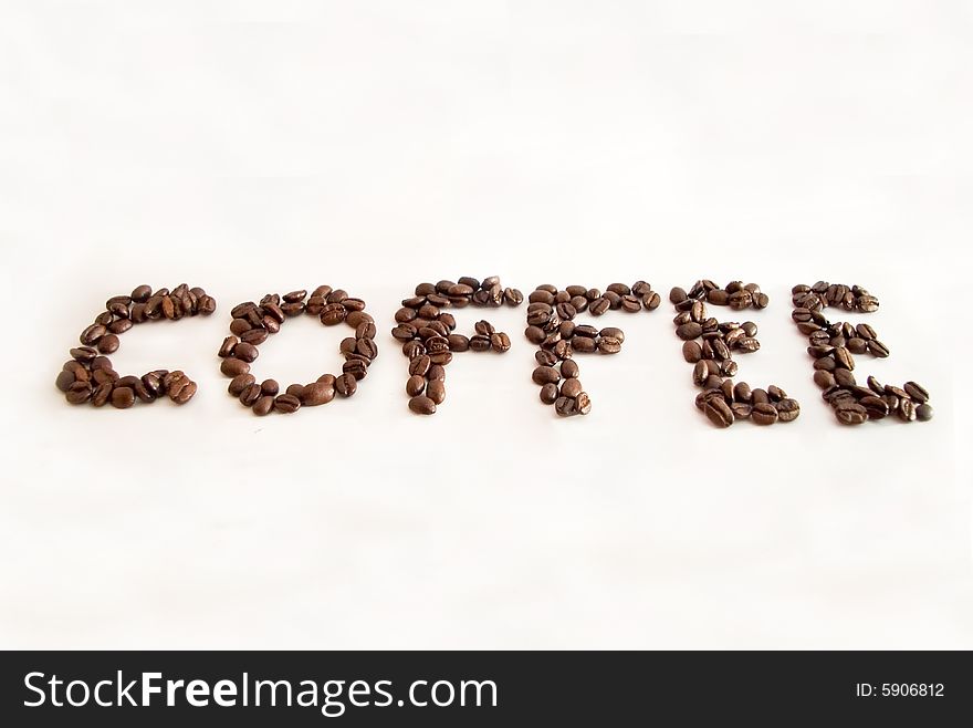 The word coffe made with coffee beans and isolated on a white background. The word coffe made with coffee beans and isolated on a white background