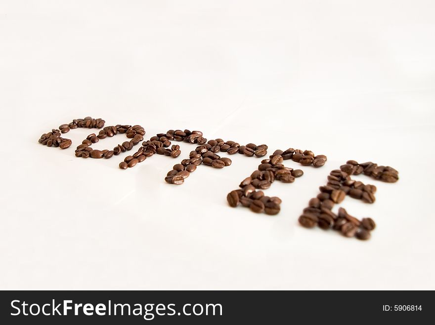 The word coffe made with coffee beans and isolated on a white background