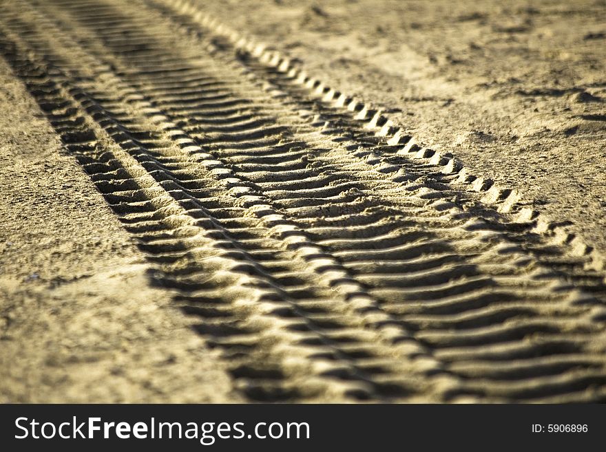 Tire`s tracks printed in the sand. Tire`s tracks printed in the sand