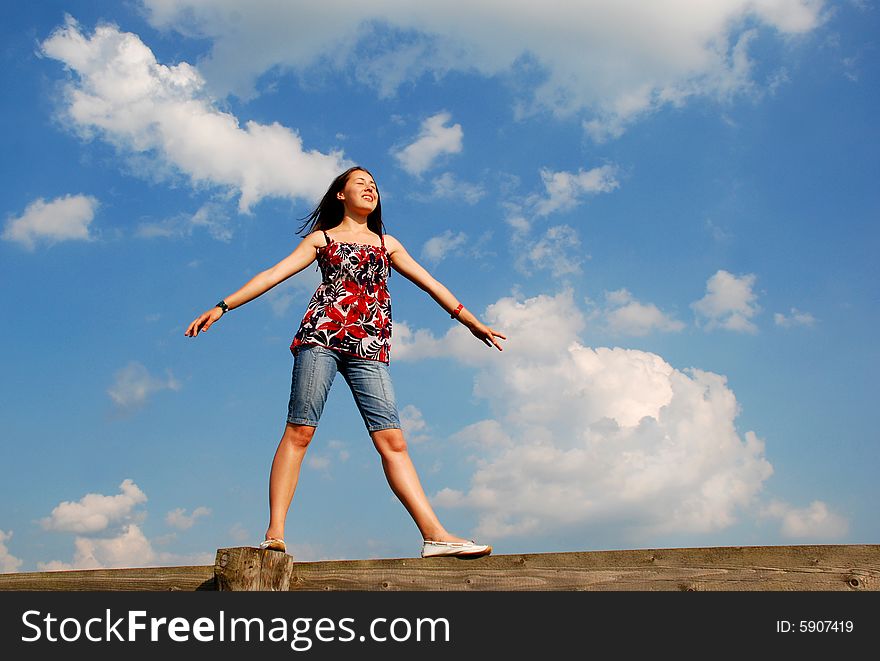 Portrait of the young beautiful woman on a background of the sky