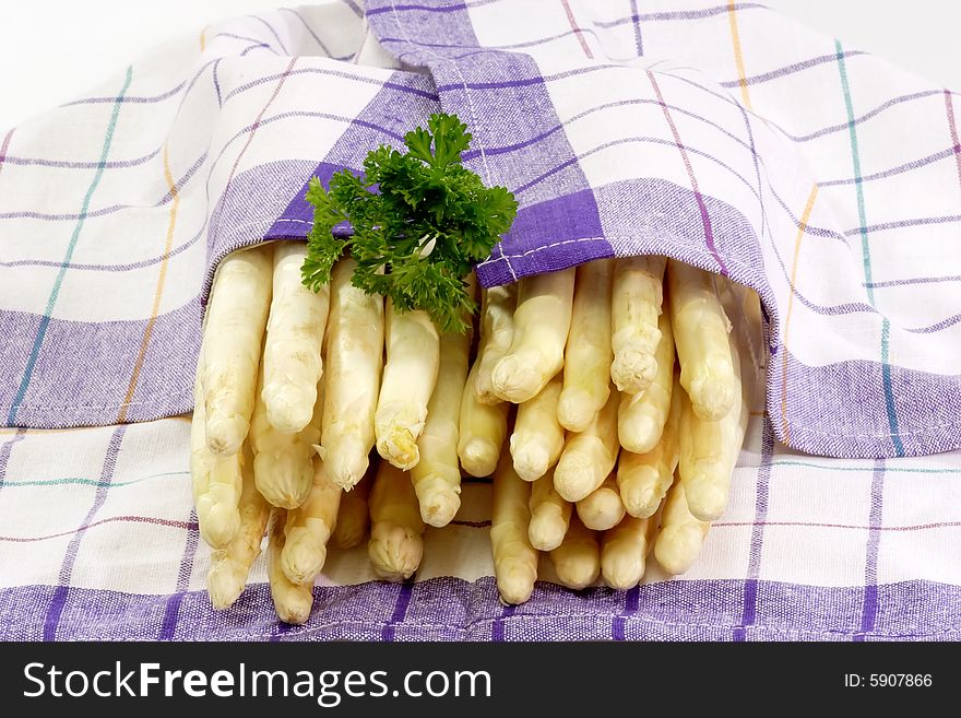 Fresh asparagus wrapped in a kitchen towel. Fresh asparagus wrapped in a kitchen towel