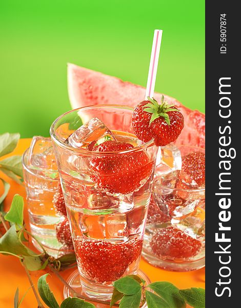 Fresh iced drink (water) served with strawberries. Fresh iced drink (water) served with strawberries