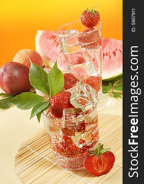 Fresh iced drink (water) served with strawberries. Fresh iced drink (water) served with strawberries