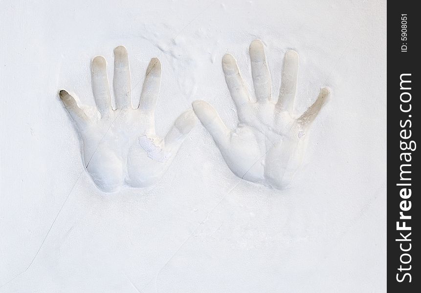 Plaster hands relief on wall