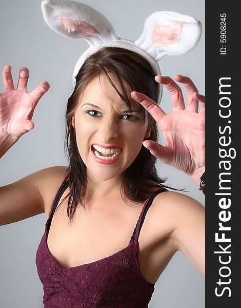 Dark haired woman with bunny ears being angry