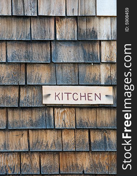 Kitchen sign on shingle cabin wall