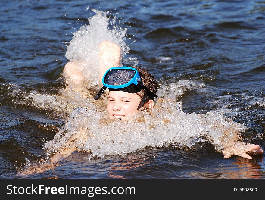 The boy swimming fast in a lake late afternoon. The boy swimming fast in a lake late afternoon.