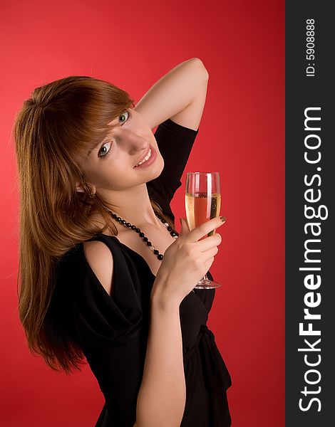 Smiling girl with champagne glass isolated on red background