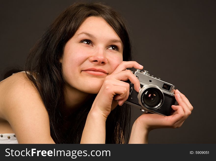 Romantic girl with retro camera isolated in studio