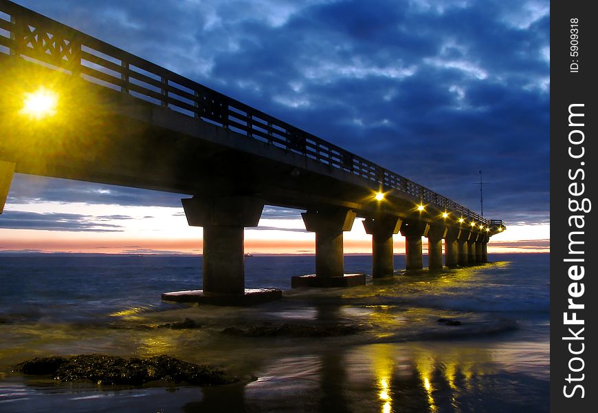 Low light photo of a pier at sunrise. Low light photo of a pier at sunrise