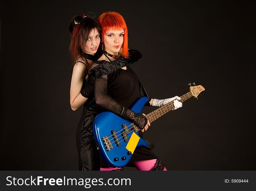 Two rock girls hugging isolated on black background