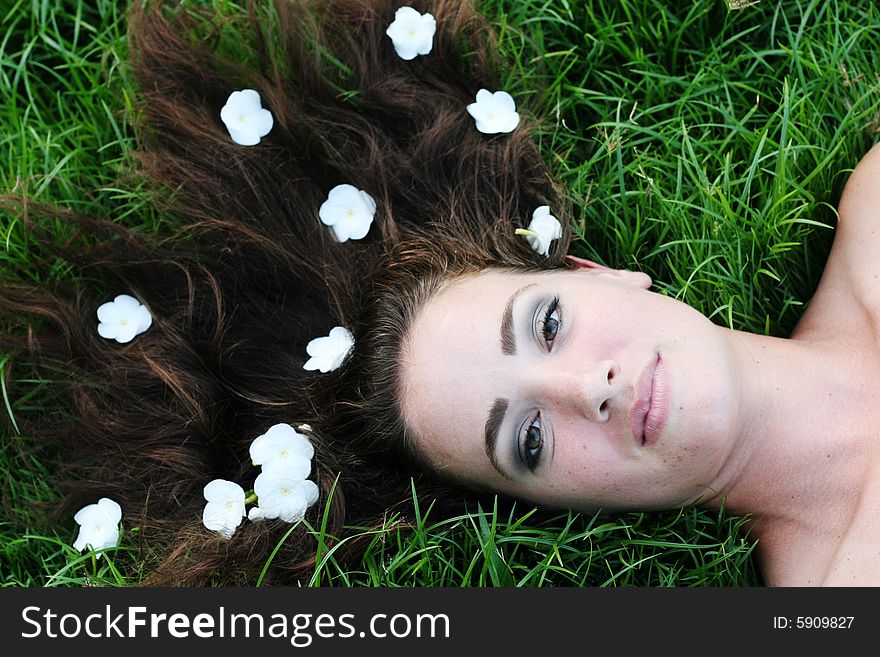 Portrait of a beautiful young woman with flowers in her hair.
