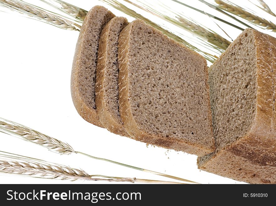 Bread and wheat isolated on white background