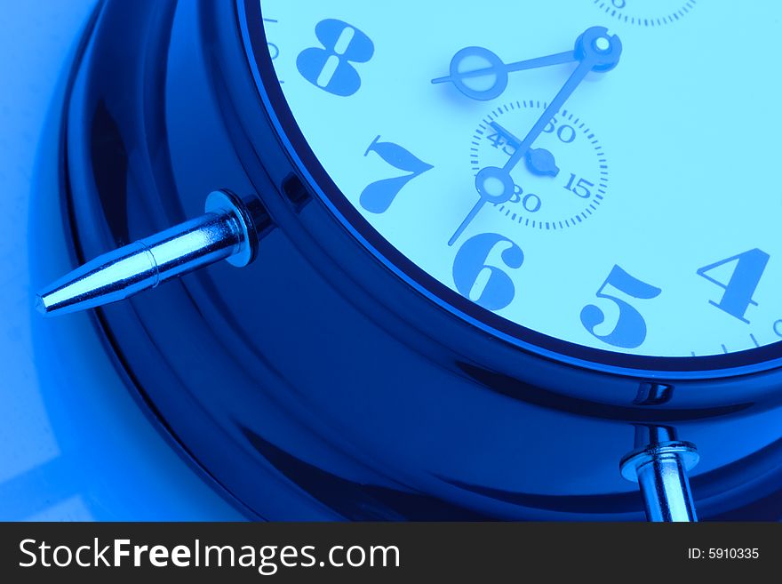 Close-up image of a clock face - blue tint. Close-up image of a clock face - blue tint.