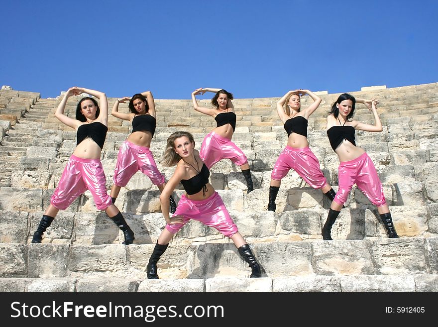 Beautiful modern dancers on the ancient stairs of  Kurion amphitheatre in Cyprus.