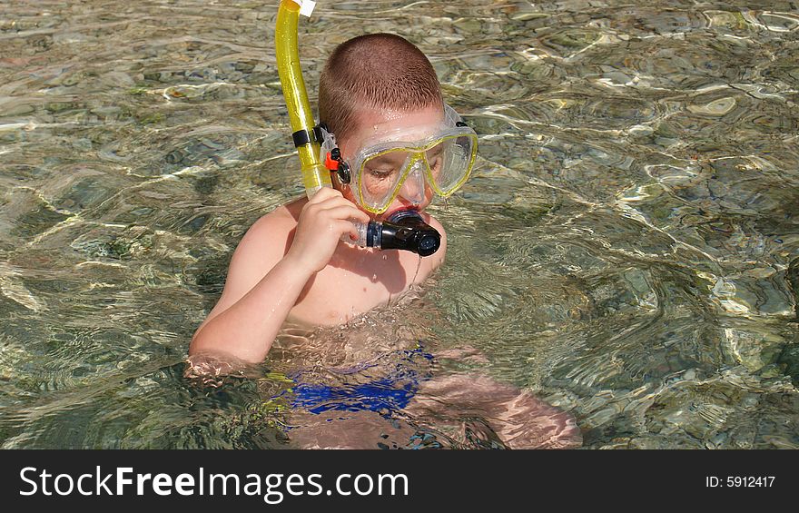 Little boy is trying his snorkeling devices. Little boy is trying his snorkeling devices
