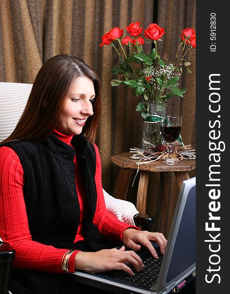 Brunette Female working from home on her laptop computer