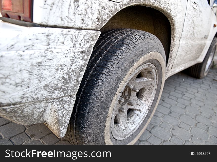 Closeup of dirty truck, at a parking after off-road driving