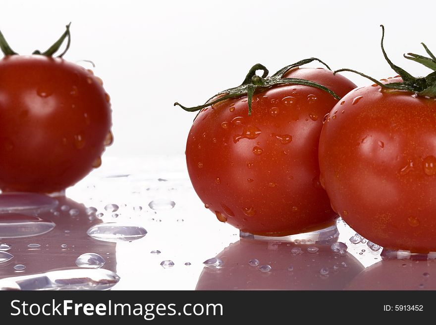 Fresh tomatoes wtih water drops.