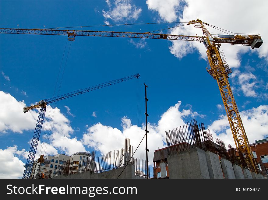 The building crane on a background of the blue sky. The building crane on a background of the blue sky
