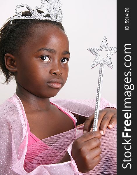 Young girl wearing a pink fairy costume with accessories