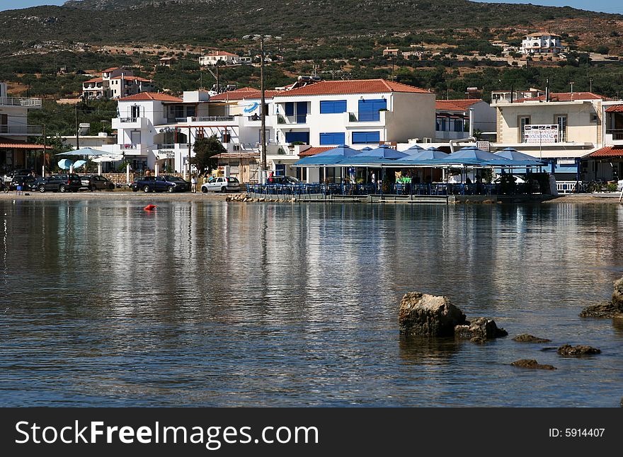 A view of a Greek island with buildings and restaurants. A view of a Greek island with buildings and restaurants