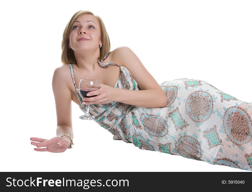 Beautiful woman lays on a white background with a glass of red wine in a hand. Beautiful woman lays on a white background with a glass of red wine in a hand