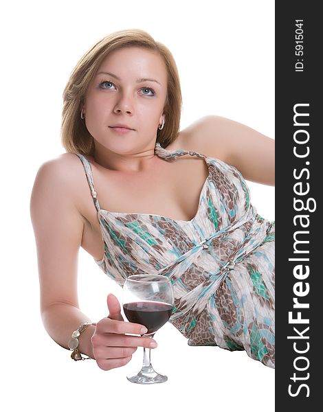 Beautiful woman lays on a white background with a glass of red wine in a hand. Beautiful woman lays on a white background with a glass of red wine in a hand