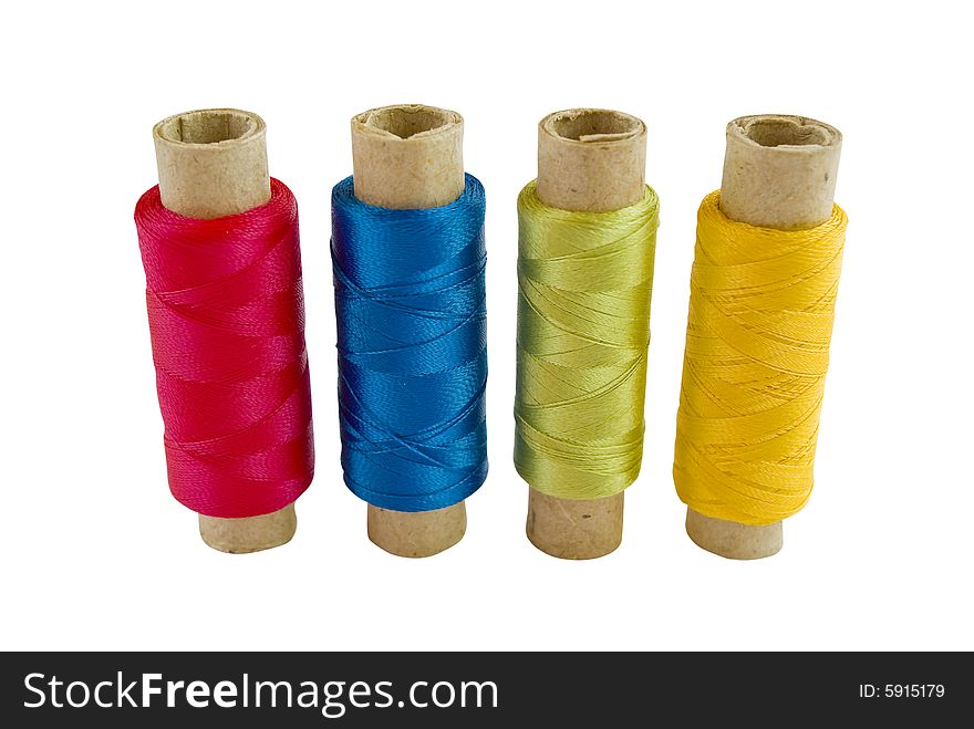 Four colored thread spools isolated on white background