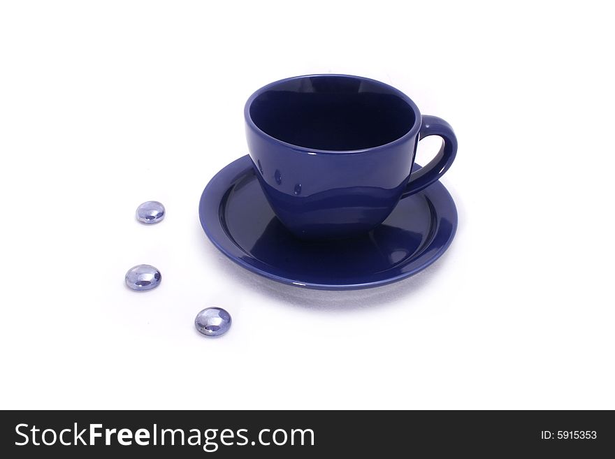 Cup and saucer on white background with stones