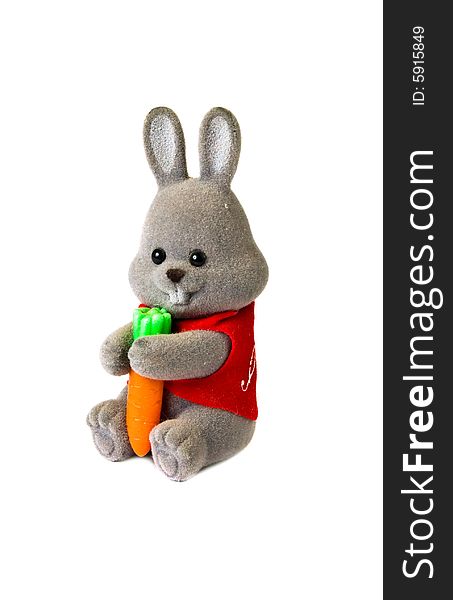 Close-up toy rabbit with carrot isolated on white