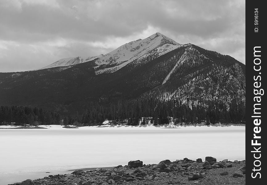 A winter image of a mountain over a frozen lake in Colorado. A winter image of a mountain over a frozen lake in Colorado.