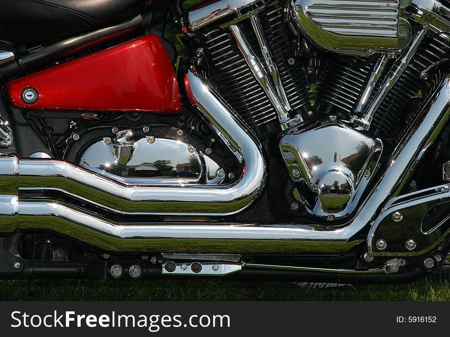 Close-up of a side and motor motorcycle with chrome shiny details. Close-up of a side and motor motorcycle with chrome shiny details.