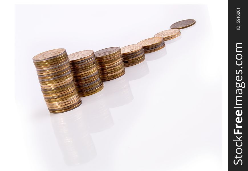 Growing stacks of coins with reflections on a white backround. Growing stacks of coins with reflections on a white backround