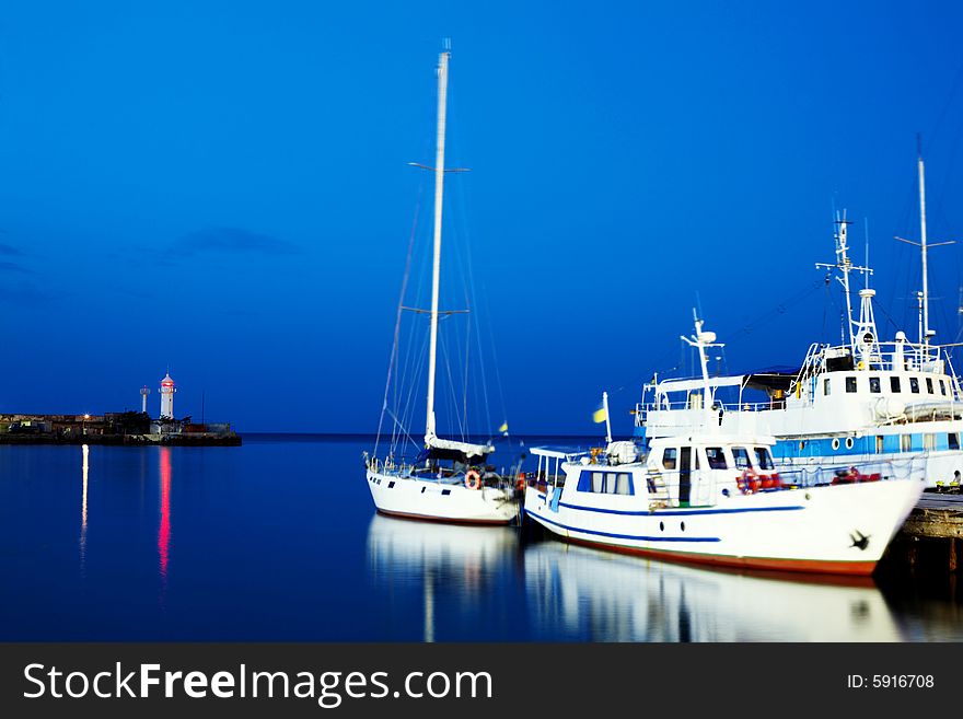 Boats near the pier. Shot at night.