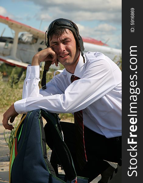 The Young man with parachute on background of the airplane-biplane. The Young man with parachute on background of the airplane-biplane.