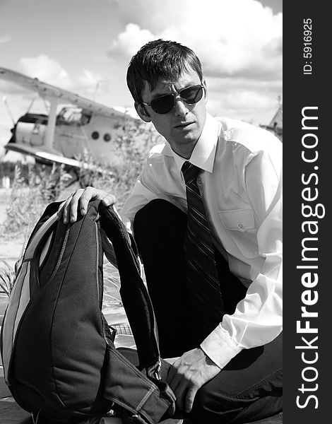 The Young man with parachute on background of the airplane-biplane. The Young man with parachute on background of the airplane-biplane.