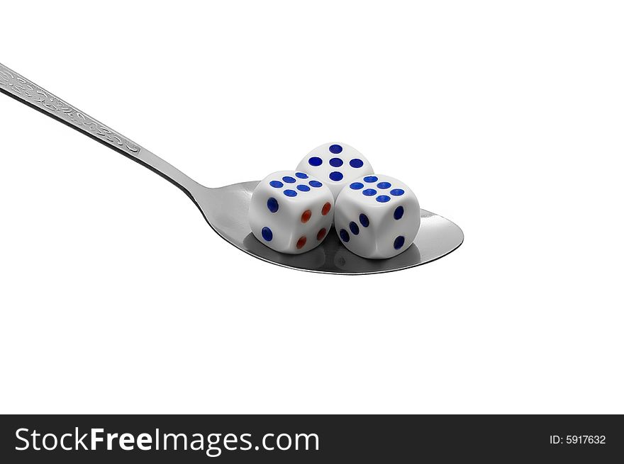 Metal spoon with dices on white background