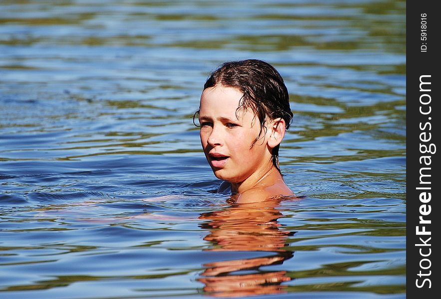 The portrait of the boy in a lake late afternoon. The portrait of the boy in a lake late afternoon.