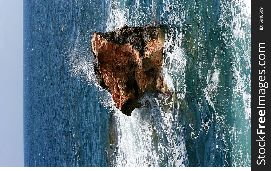 Stone in a sea, water-wave splash