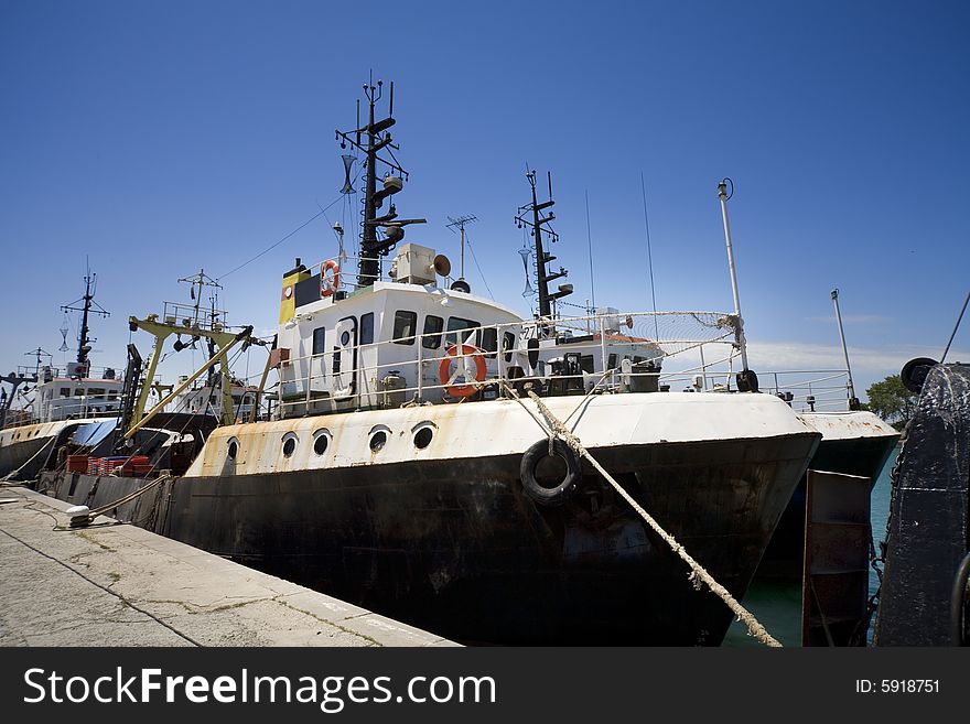 A fishing boat on dock and blue sky