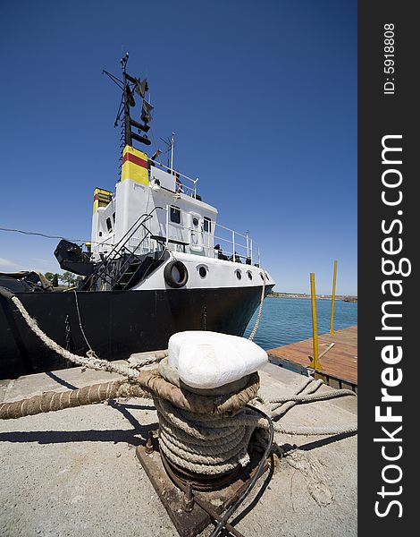 A fishing boat on dock and blue sky