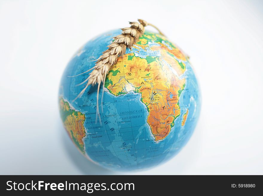 Wheaten ripe ear above the globe. Wheaten ripe ear above the globe
